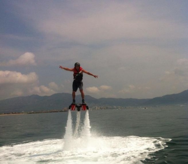  man in the air while flyboarding 